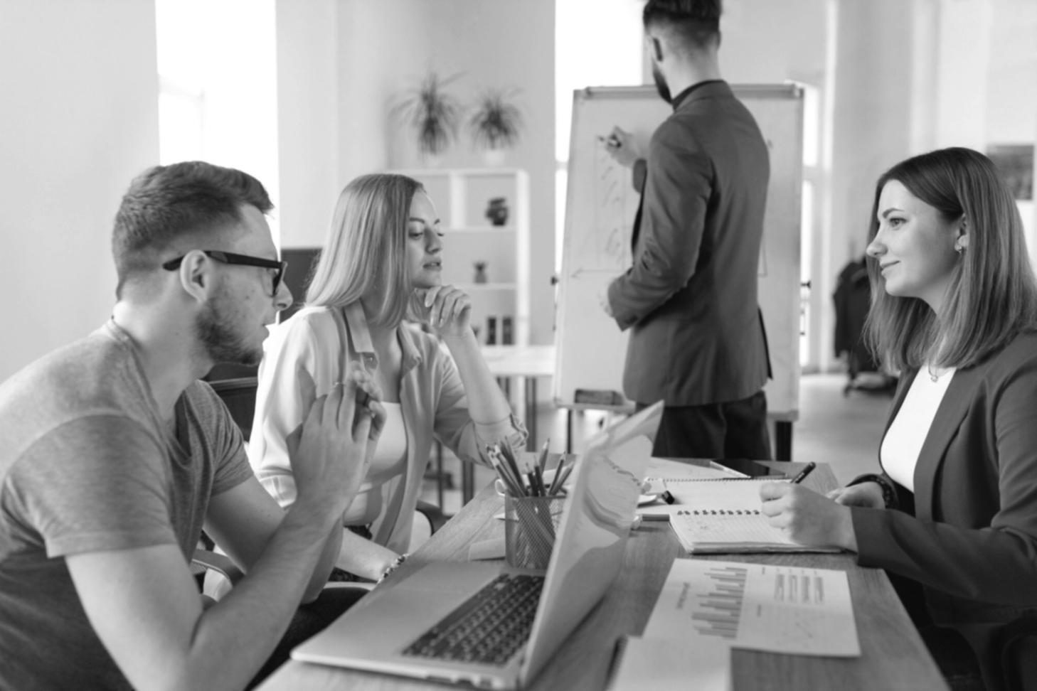 Collaborative business planning session with strategic documents and growth analysis